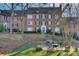 The rear of the red brick apartment building boasts a picnic area on a grassy knoll at 101 S Laurel Ave # 72A, Charlotte, NC 28207