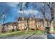 Beautiful brick apartment building with mature trees, landscaped lawn, and a sidewalk out front at 101 S Laurel Ave # 72A, Charlotte, NC 28207