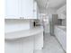Bright condo kitchen with white cabinets, sleek countertops, and stainless steel appliances at 101 S Laurel Ave # 72A, Charlotte, NC 28207