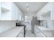 Bright, modern kitchen boasts crisp white cabinets, sleek countertops, and stainless-steel appliances at 101 S Laurel Ave # 72A, Charlotte, NC 28207