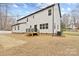 Back of home features white siding, black trim, a small deck and staircase to backyard at 10405 Briarhurst Pl # 18, Mint Hill, NC 28227