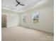 Open bedroom with large windows offers ample natural light and a neutral backdrop for personalized décor at 10405 Briarhurst Pl # 18, Mint Hill, NC 28227