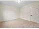 Empty bedroom featuring neutral walls, carpet, and a single door entry at 10405 Briarhurst Pl # 18, Mint Hill, NC 28227