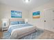 Bedroom with neutral colored carpet, a large bed, and blue accents at 10405 Briarhurst Pl # 18, Mint Hill, NC 28227
