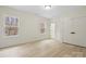 Bright bedroom featuring two windows, closet, ensuite access, and plank floors at 10405 Briarhurst Pl # 18, Mint Hill, NC 28227