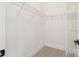 Walk-in closet with white wire shelving and neutral carpet at 10405 Briarhurst Pl # 18, Mint Hill, NC 28227