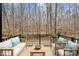 Deck with outdoor furniture overlooking a scenic wooded area at 10405 Briarhurst Pl # 18, Mint Hill, NC 28227