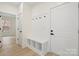 Bright entryway with white shiplap accent wall, coat hooks, and built-in bench and storage at 10405 Briarhurst Pl # 18, Mint Hill, NC 28227