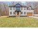 Beautiful two-story home featuring a well-manicured lawn and a two-car garage at 10405 Briarhurst Pl # 18, Mint Hill, NC 28227