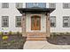 Inviting front entrance with wood double doors and brick-accented porch at 10405 Briarhurst Pl # 18, Mint Hill, NC 28227