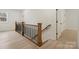Upstairs hallway featuring hardwood floors and a railing with black metal pickets at 10405 Briarhurst Pl # 18, Mint Hill, NC 28227