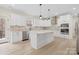 Open kitchen featuring modern appliances, white cabinets, marble countertops, and an island with seating at 10405 Briarhurst Pl # 18, Mint Hill, NC 28227