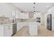 Bright kitchen featuring island, stainless steel appliances, and modern finishes at 10405 Briarhurst Pl # 18, Mint Hill, NC 28227