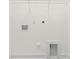 The laundry room features a tiled baseboard and the washer/dryer hookups with a shelf overhead at 10405 Briarhurst Pl # 18, Mint Hill, NC 28227
