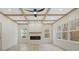Bright living room featuring coffered ceilings, a modern fireplace, and large windows at 10405 Briarhurst Pl # 18, Mint Hill, NC 28227
