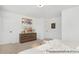 Bright bedroom with a wooden dresser, cozy bedding, and natural light at 11315 Magpie Ct # 3, Charlotte, NC 28215