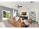 Spacious living room filled with natural light from sliding glass door and a modern ceiling fan at 11315 Magpie Ct # 3, Charlotte, NC 28215