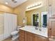 Bathroom features a shower/tub combo, toilet, and vanity with sink and warm lighting at 11406 Olde Turnbury Ct, Charlotte, NC 28277