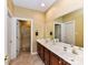 Bathroom showcasing a double vanity and an adjoining shower room at 11406 Olde Turnbury Ct, Charlotte, NC 28277