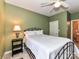 Cozy bedroom featuring a ceiling fan, a black metal bed frame, and an ensuite bathroom at 11406 Olde Turnbury Ct, Charlotte, NC 28277