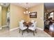Eat-in kitchen dining area with a modern chandelier and seating for four at 11406 Olde Turnbury Ct, Charlotte, NC 28277