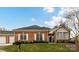 Charming brick home featuring white shutters and a well-maintained lawn, perfect for curb appeal at 11406 Olde Turnbury Ct, Charlotte, NC 28277
