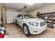 Spacious garage features a white SUV with ample storage space and a roll up door at 11406 Olde Turnbury Ct, Charlotte, NC 28277