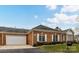 A well kept brick home with attached garage and a beautifully manicured lawn at 11406 Olde Turnbury Ct, Charlotte, NC 28277