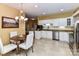 Bright eat-in kitchen with stainless appliances, white cabinets and tiled floor at 11406 Olde Turnbury Ct, Charlotte, NC 28277