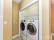 Convenient laundry area with side-by-side washer and dryer hookups and storage shelves at 11406 Olde Turnbury Ct, Charlotte, NC 28277