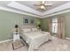 Spacious main bedroom with tray ceiling, neutral carpeting, and natural light at 11406 Olde Turnbury Ct, Charlotte, NC 28277
