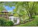 Scenic pond view featuring a gazebo, fountain, and lush landscaping creating a tranquil setting at 11406 Olde Turnbury Ct, Charlotte, NC 28277