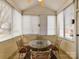 Enclosed porch perfect for enjoying the outdoors with a glass table and four chairs at 11406 Olde Turnbury Ct, Charlotte, NC 28277