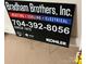 Bradham Brothers Inc. sign with contact information for heating, cooling, and electrical services at 11406 Olde Turnbury Ct, Charlotte, NC 28277