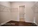 Spacious walk-in closet with wire shelving and doorway to the room at 121 N Prestwick Way # 43, Mooresville, NC 28115