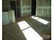 An unfinished living room showing the walls being prepped to be painted and lots of natural light at 122 Peppervine Ln, Statesville, NC 28625