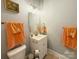 Well-lit bathroom includes a vanity with storage, mirror, and complementing orange-colored towels at 127 E 11Th St, Salisbury, NC 28144