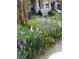 Charming front yard boasts colorful flowers, shrubs, and a quaint fence, enhancing curb appeal at 127 E 11Th St, Salisbury, NC 28144
