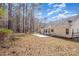 A view of the backyard with the rear of the home and a concrete patio at 12810 English Walnut Ln, Charlotte, NC 28215