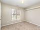 Neutral secondary bedroom with a single window, neutral carpet, and ample space at 12810 English Walnut Ln, Charlotte, NC 28215