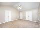 Neutral primary bedroom with double closets, ceiling fan, and lots of natural light at 12810 English Walnut Ln, Charlotte, NC 28215