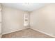 Neutral bedroom with wall-to-wall carpet and one window allowing natural light at 12810 English Walnut Ln, Charlotte, NC 28215