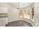 Dining area featuring hardwood floors, natural light, and modern chandelier fixture at 12810 English Walnut Ln, Charlotte, NC 28215