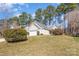 Charming single-Gathering home with a two-car garage, a well-manicured lawn, and a lovely landscape under a sunny sky at 12810 English Walnut Ln, Charlotte, NC 28215