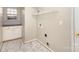 Laundry room with tile flooring and overhead shelving at 12810 English Walnut Ln, Charlotte, NC 28215