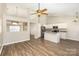 Open-concept living area showcases vaulted ceilings, wood floors, and stainless steel appliances at 12810 English Walnut Ln, Charlotte, NC 28215