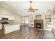 Bright and open living space with hardwood floors and a cozy fireplace, adjacent to the modern kitchen at 12810 English Walnut Ln, Charlotte, NC 28215