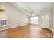 Bright living room features vaulted ceilings, and a large window overlooking the front yard at 12810 English Walnut Ln, Charlotte, NC 28215