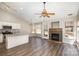 Bright and open living space with hardwood floors and a cozy fireplace, adjacent to the modern kitchen at 12810 English Walnut Ln, Charlotte, NC 28215