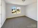 Bedroom with carpet, a large window, and white walls at 13603 Whitebark Ct, Charlotte, NC 28262